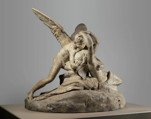 Canova's Cupid and Psyche: two figures in an embrace, Psyche reaching up to touch Cupid's face, carved so the surface reads as skin rather than stone.
